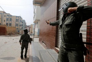 A riot policeman prepares to launch stones with a slingshot towards protesters demonstrating against alleged corruption in the provincial town of Imzouren, Morocco, June 2, 2017. A Reuters reporter saw protesters tossing rocks and trash towards riot police in Imzouren, a town 450 km (279 miles) northeast of the capital Rabat. Police responded occasionally with water cannon salvoes. REUTERS/Youssef Boudlal